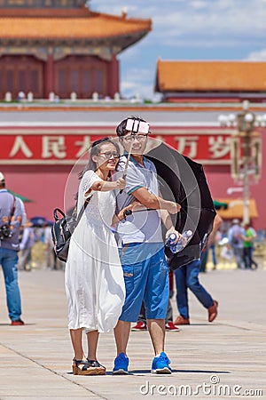 Couple takes a selfie on sunny Tiananmen Square, Beijing, China Editorial Stock Photo